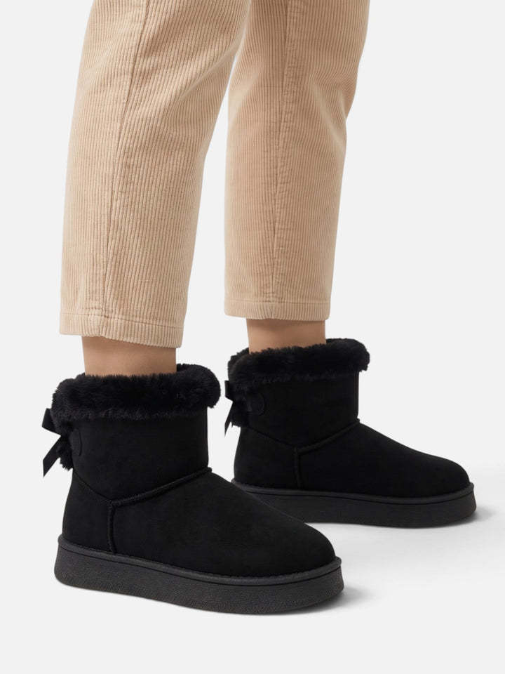 Fodrade boots i mockaimitation med rosett för dam