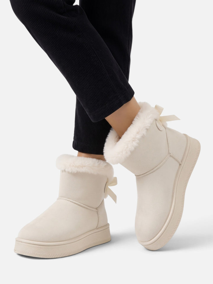 Fodrade boots i mockaimitation med rosett för dam